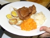 Fresh butchered pork belly with coconut candied yams and garlic and sour cream potatoes