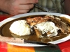 Enchiladas with with black mole and topped with beef
