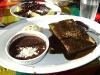 A chicken tamal with black mole