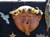 A terra cotta sculpture at a vendor booth at the garlic festival