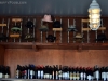 A collection of Larry Bell's signature hats perched above the bar