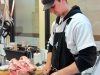 Cleaning the meat off pig heads for scrapple