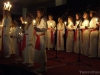 Lucia leads the choir in holiday song