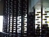 A wall of bottles frames a private lounge area