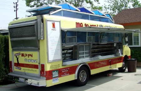 The bright yellow BBQ truck is coming your way