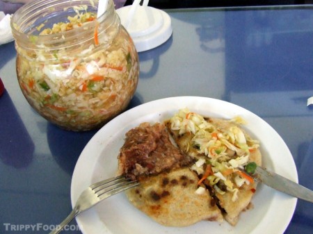 Pupusa ruvuelta topped with curtido