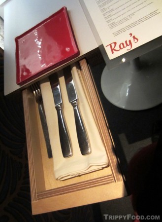 Silverware is hidden in a drawer at the table