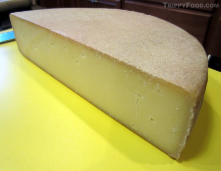 A half-wheel of raclette cheese