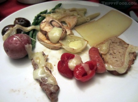 Assorted cheese-draped food for raclette
