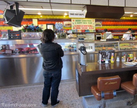 A customer fights the urge to sit in Al Langer's chair