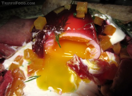 The borscht egg's yolk cascades across the dish
