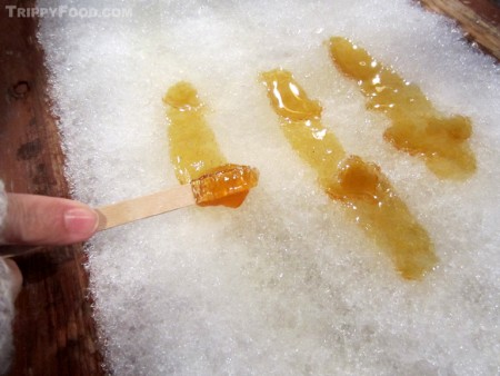 Rolling maple toffee onto a stick