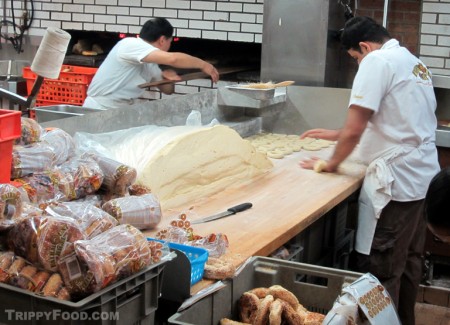 Cutting bagels from dough by hand