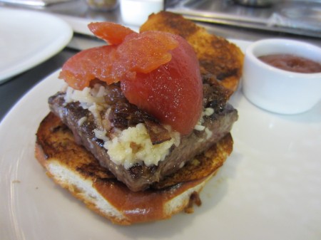 Ketchup tomatoes crown the short rib burger