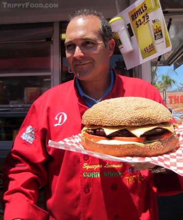 Dominic Palmieri shows of his burger featuring a 4 lb. patty