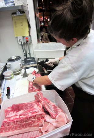 Sous Chef Kathryn Christensen breaks down a rack of ribs